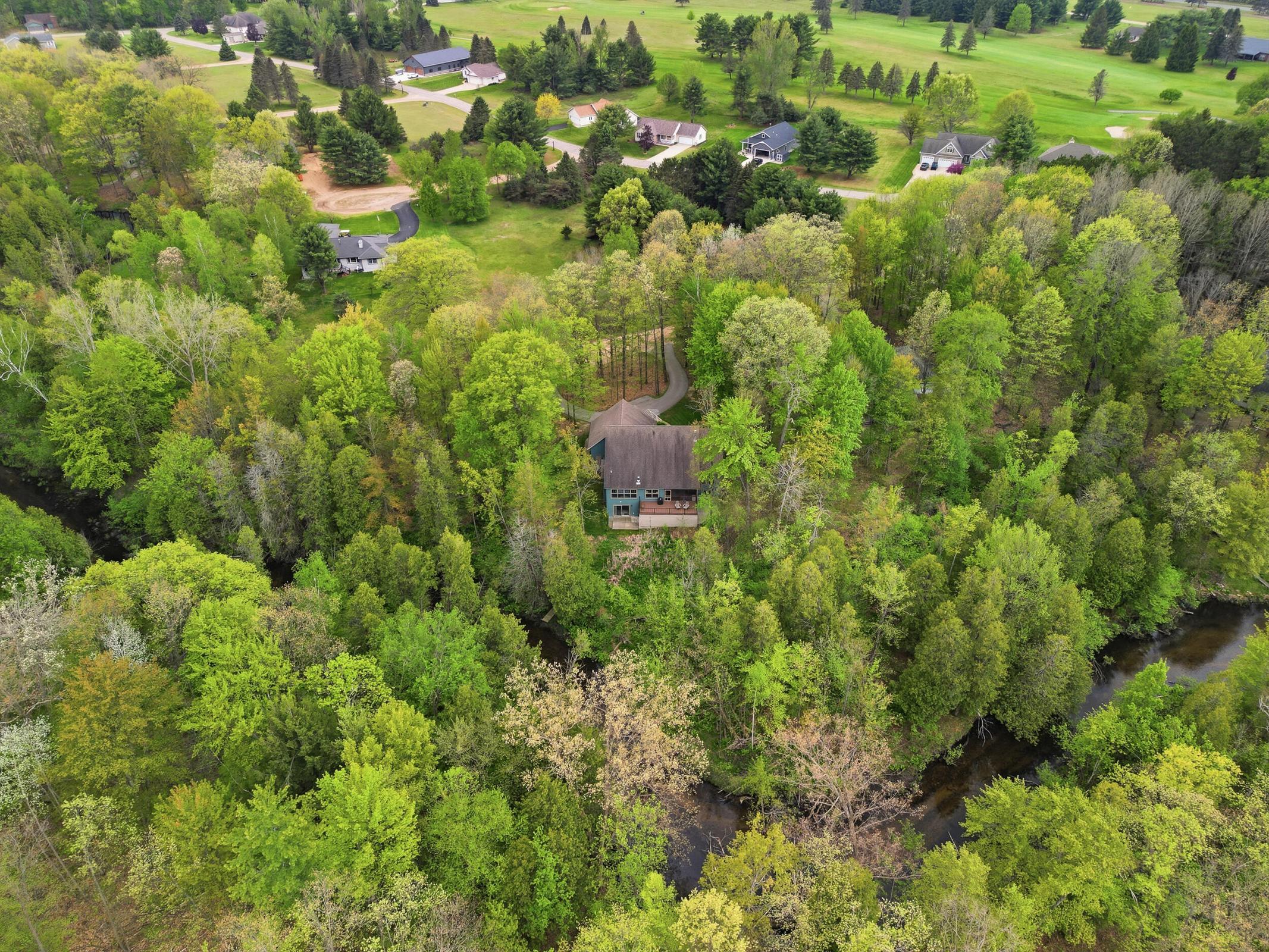 Tucked away on over an acre along the Little Muskegon River in the hea – image 51