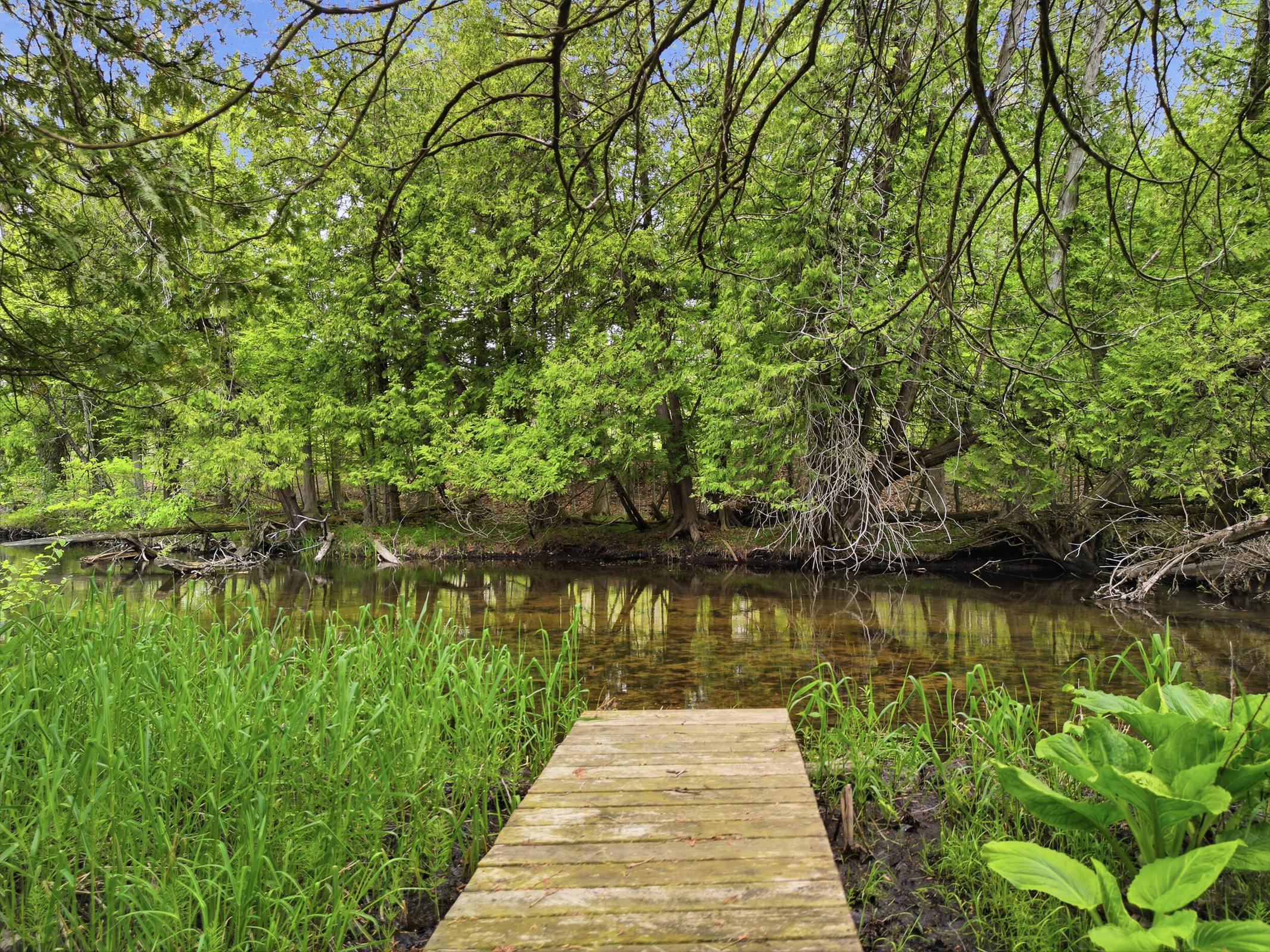 Tucked away on over an acre along the Little Muskegon River in the hea – image 8