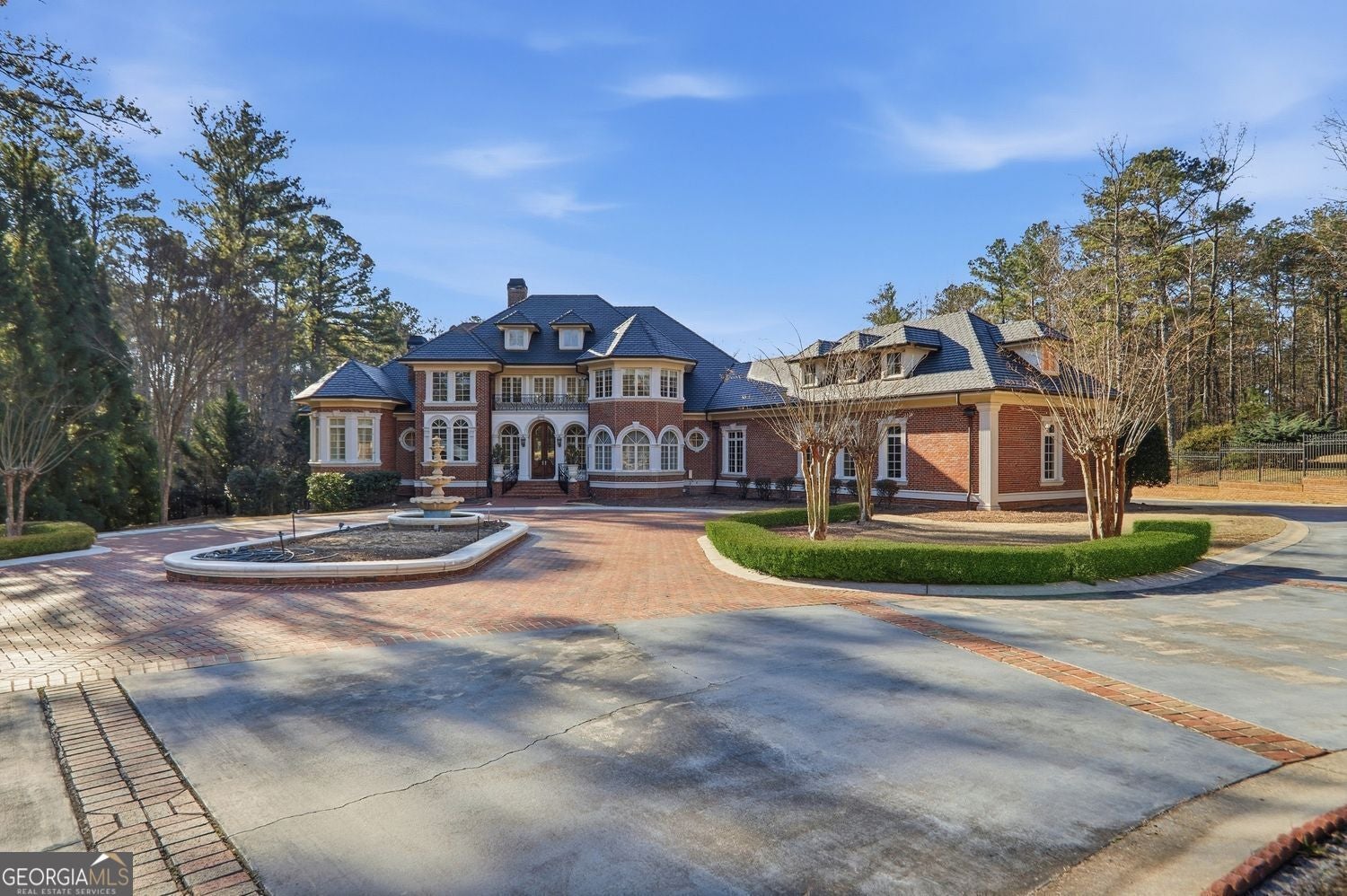 Set on 3.8 beautifully manicured acres, this elegant gated estate offe – image 77
