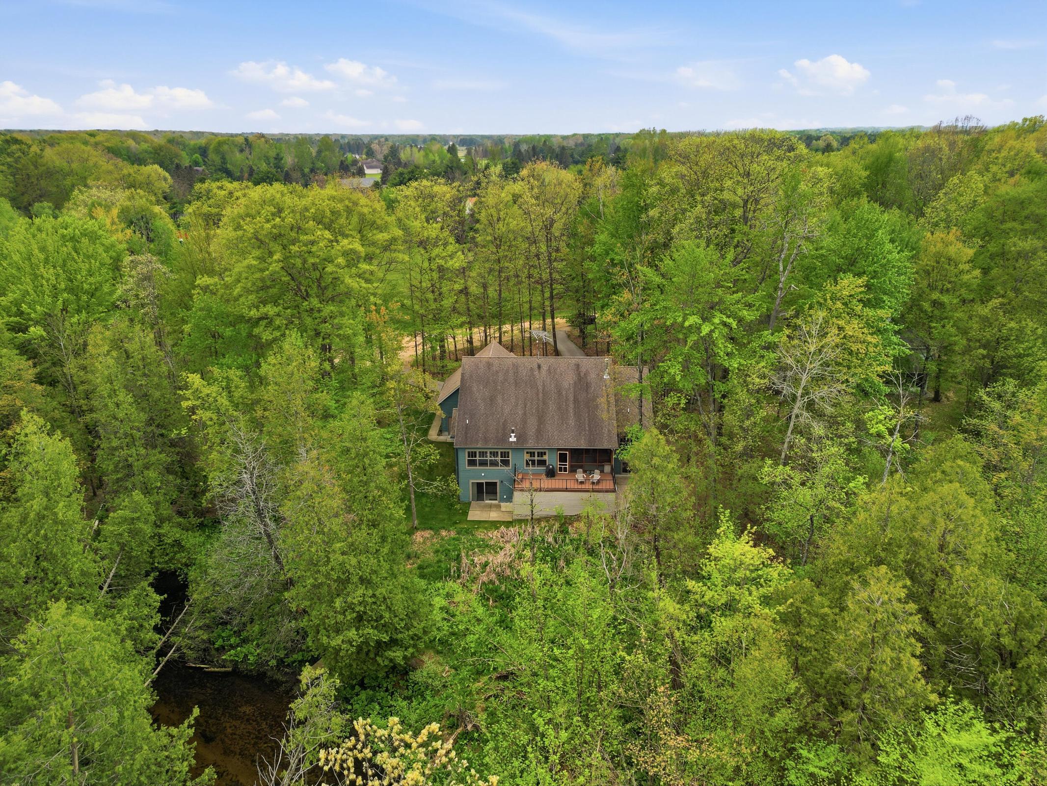 Tucked away on over an acre along the Little Muskegon River in the hea – image 7