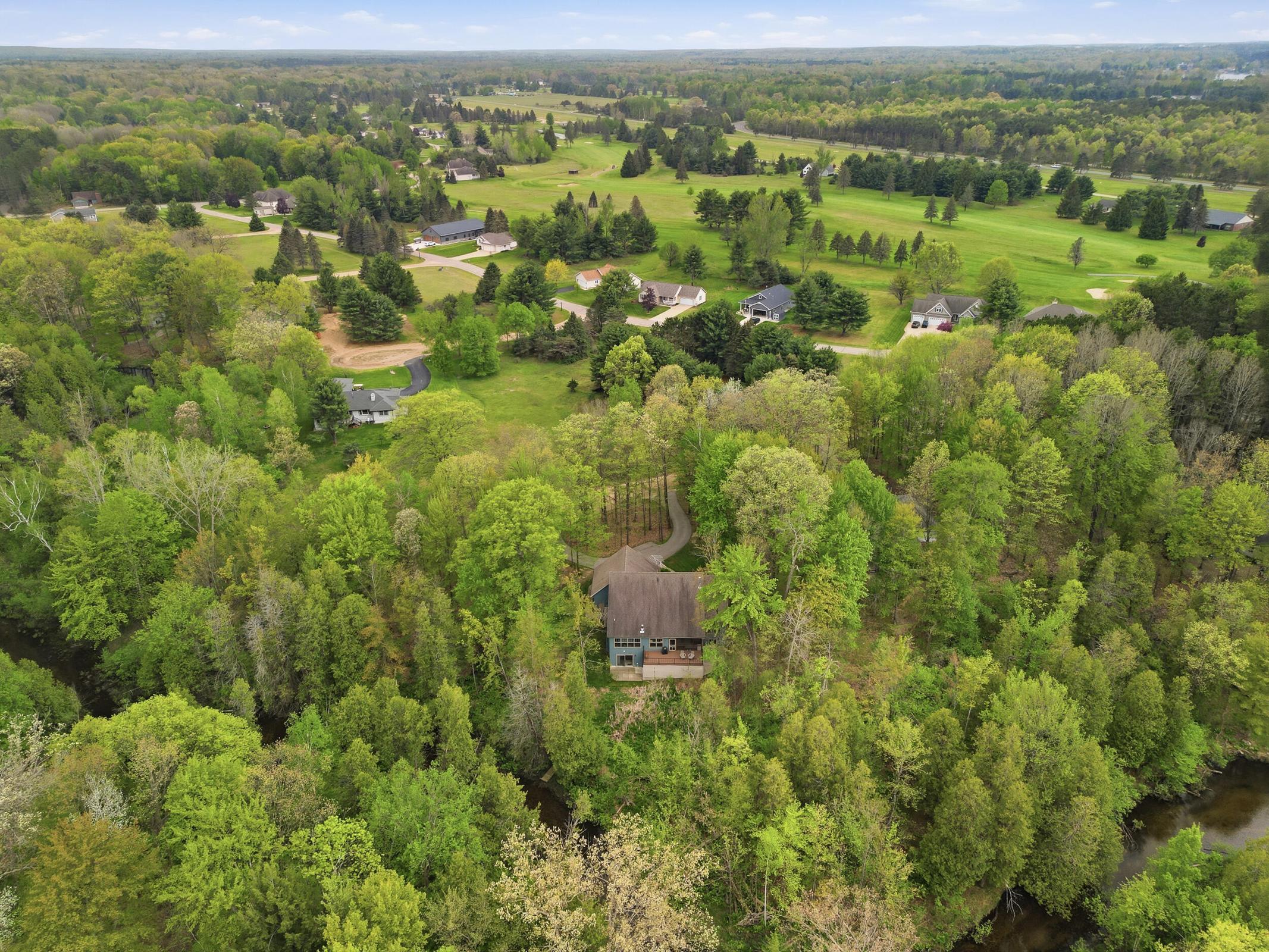 Tucked away on over an acre along the Little Muskegon River in the hea – image 2