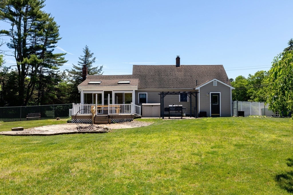 Nestled on over 2 acres, this Classic New England Cape offers the perf – image 2
