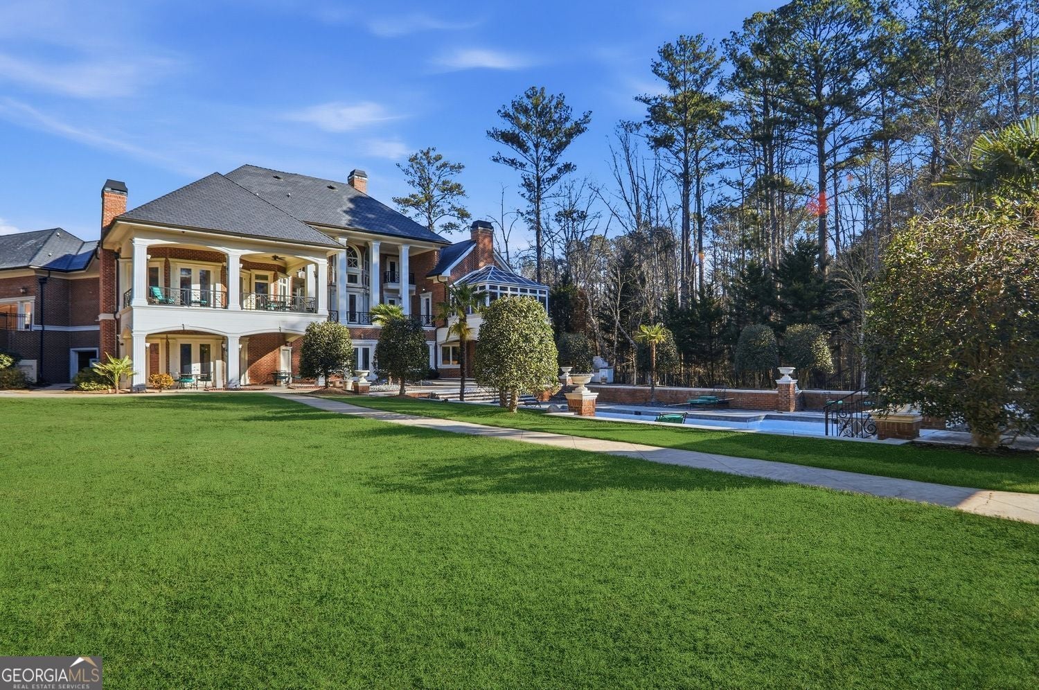 Set on 3.8 beautifully manicured acres, this elegant gated estate offe – image 141