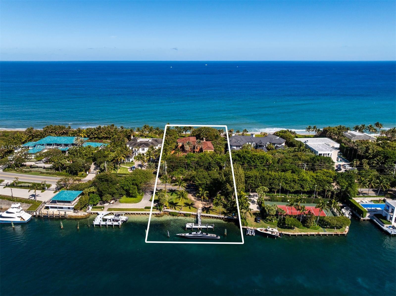 Aerial view of an outlined waterfront property with a dock and boat facing the ocean.